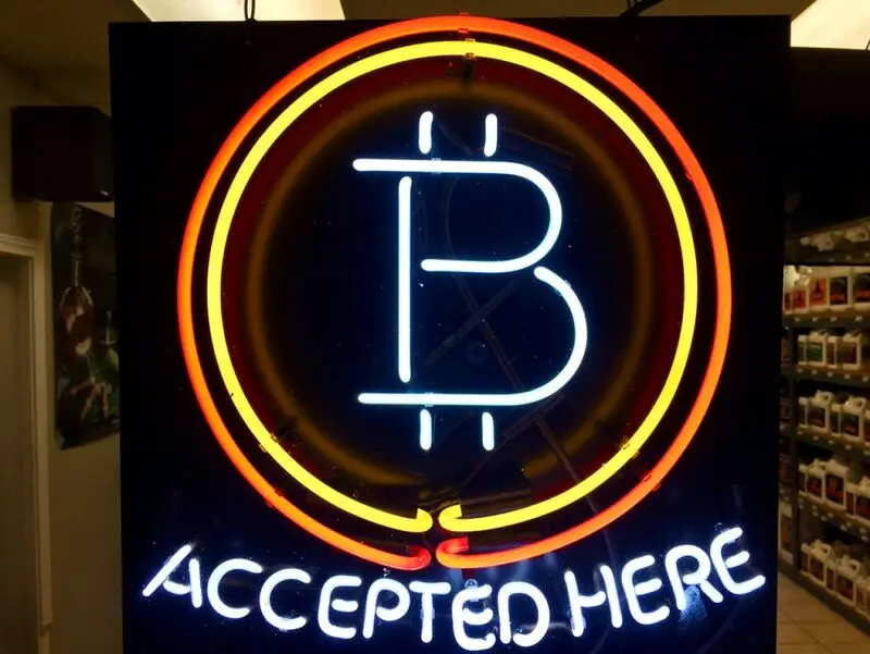 File, photo, a neon sign hanging in the window of Healthy Harvest Indoor Gardening in Hillsboro, Ore., shows that the business accepts bitcoin as payment.